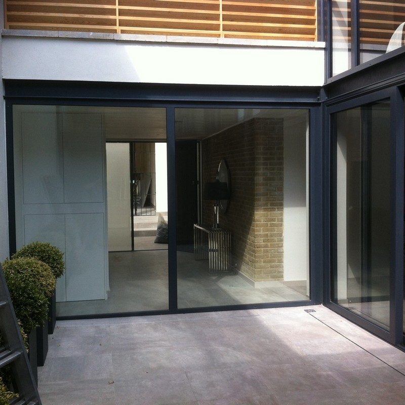 Floor-to-ceiling sliding doors opening to courtyard in Enfield