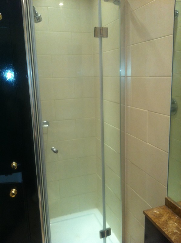 Frameless glass shower enclosure with chrome fittings in Enfield