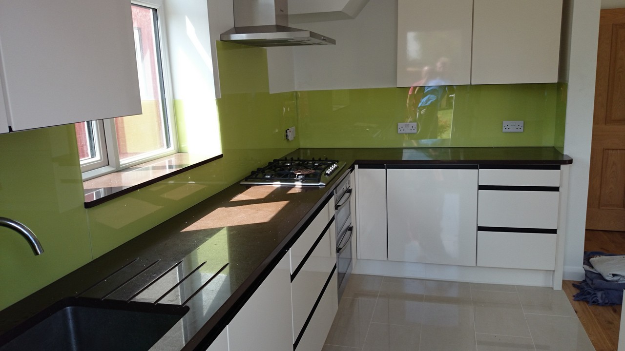 Lime green glass kitchen splashback installed by Enfield glaziers