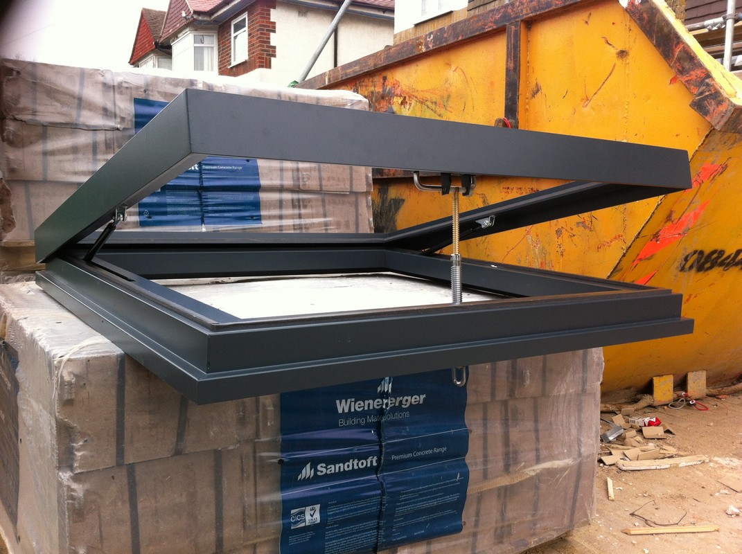 Opening flat roof skylight in anthracite grey installed in Enfield